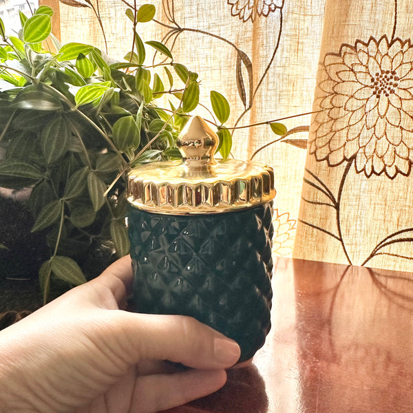 Green and gold jar candle
